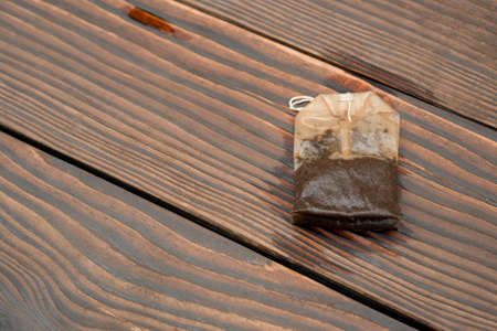 used teabag on a wooden backgroundの写真素材