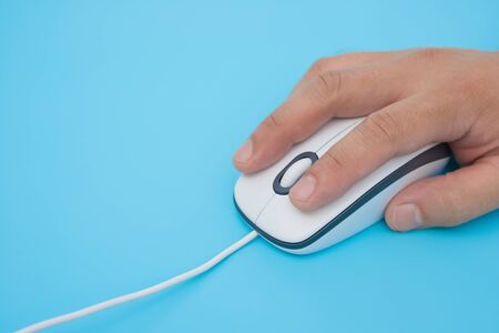 man using a white mouse on a blue background