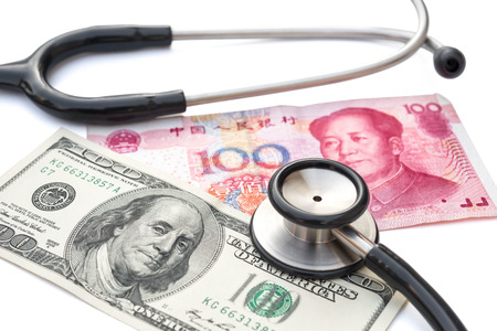 usd and rmb with stethoscopeの写真素材