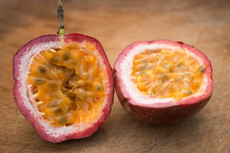 Close up to cut passion fruit on a wooden backgroundの写真素材