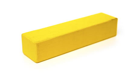 piece of yellow wooden toy block on white backgroundの写真素材