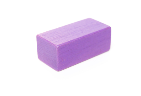 piece of purple wooden toy block on white backgroundの写真素材