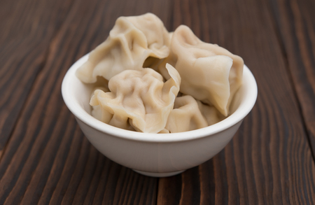 bowl full of dumpling on wooden backgroundの写真素材