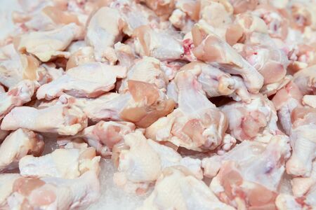 raw chicken legs on top of ice on sale in surpermarketの写真素材