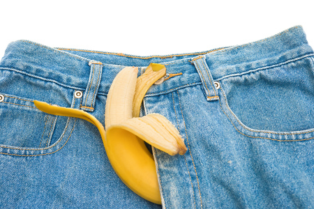 big banana sticks out of mens jeans like mens penis as potency conceptの写真素材
