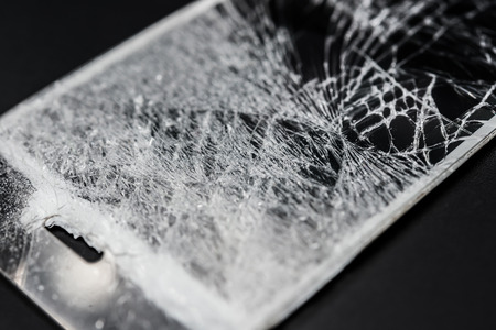 broken screen of a smart phone on a black background