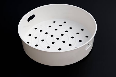 white plastic steamer on black backgroundの写真素材
