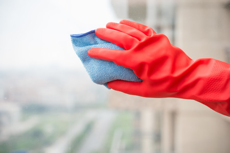 man cleaning the window with red gloveの写真素材