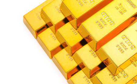 pieces of gold bars stacked up on a white backgroundのeditorial素材