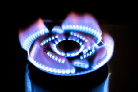 gas burning from a kitchen gas stove in darkの写真素材