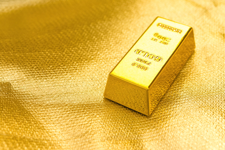 piece of gold bar on a golden background