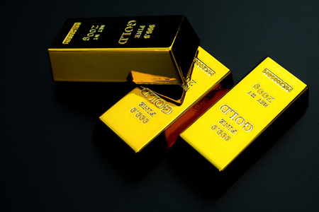 three pieces of gold bar on a black backgroundの写真素材