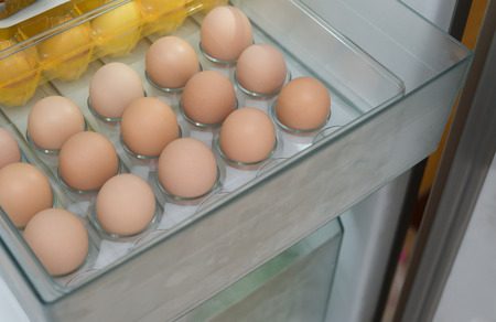 fresh eggs in a shelf of refrigeratorの写真素材