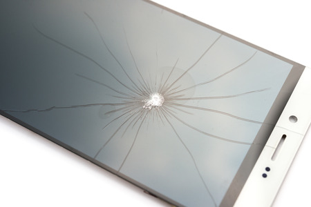 broken screen of a smart phone on a white backgroundの写真素材