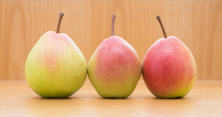 three fresh pears on a wood backgroundの写真素材