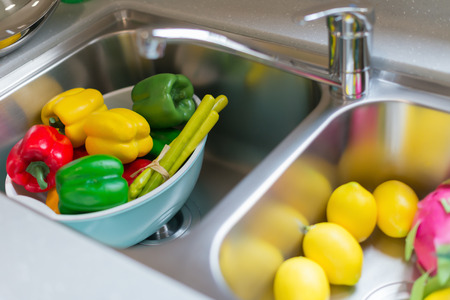 dummy ripe fruits and vegetable in sink at a morden kitchenの写真素材