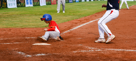 ZHONGSHAN, GUANGDONG,China - October 28:player running to the base to get one point in a baseball match on October 28, 2016.のeditorial素材