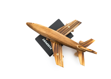 top view airplane model on top of a passport on white backgroundの写真素材