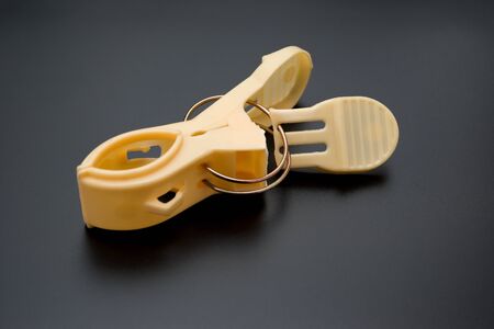 broken clothespin on a black background