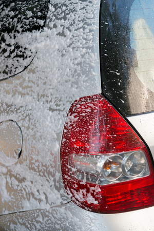 washing a car with soapy waterの写真素材