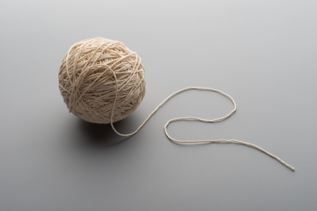 ball of threads on grey backgroundの写真素材