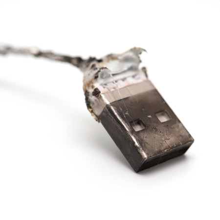 burnt out usb cable close up on whiteの写真素材