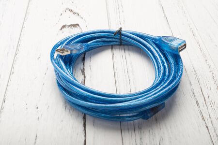 blue usb cable on a white wood backgroundの写真素材