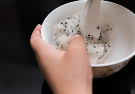 kid eating fresh dragon fruitの写真素材