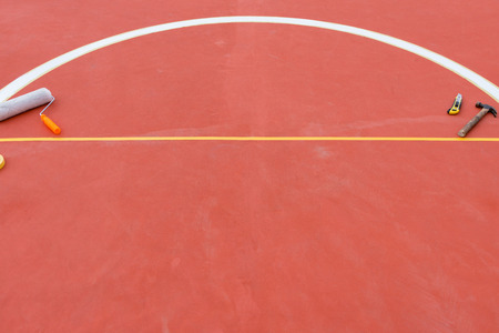 hammer, blade and paint roller on groundの写真素材