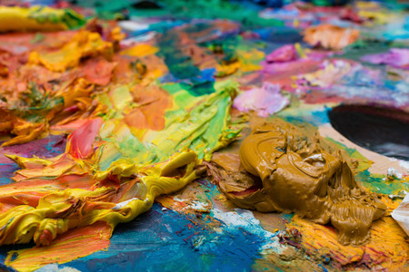 bright oil paint palette close upの写真素材