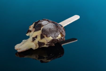 chocolate outer ice cream and beans inside with the last bit on a black background close upの写真素材