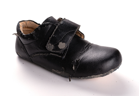 a badly broken leather shoe on white backgroundの写真素材