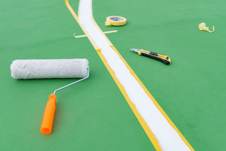 sideline for an outdoor stadium being prepared with tools