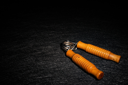 wooden handles hand trainer highlighted on dark backgroundの写真素材