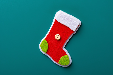 cute colorful christmas sock on a green backgroundの写真素材
