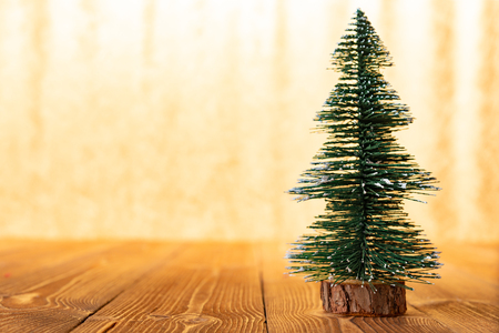 Christmas model in front of a bright golden backgroundの写真素材