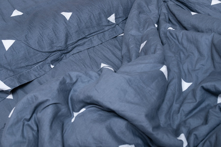 pillow and quilt on bed in bedroom