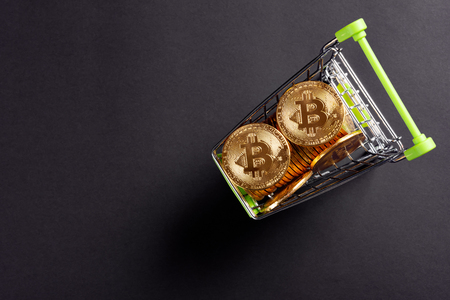 top view of bitcoins in a shopping cart on dark backgroundの写真素材
