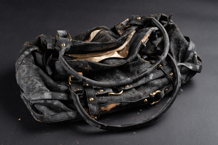 moldy leather bag on dark backgroundの写真素材