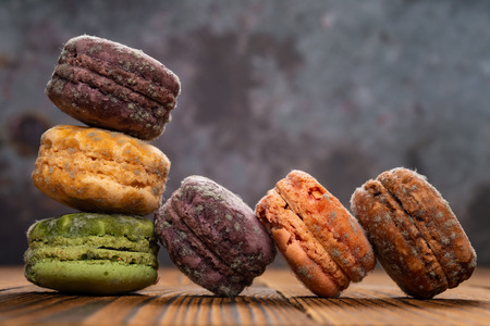 moldy macaroons on a wood table, close up
