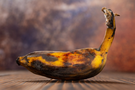 overripe banana on a wood tableの写真素材