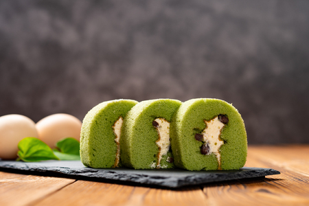 sweet rolls made of green tea and mung bean with eggs on backgroundの写真素材