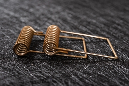 side view two pieces rusty springs on dark background