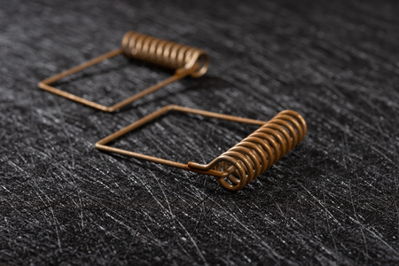 side view two pieces rusty springs on dark background
