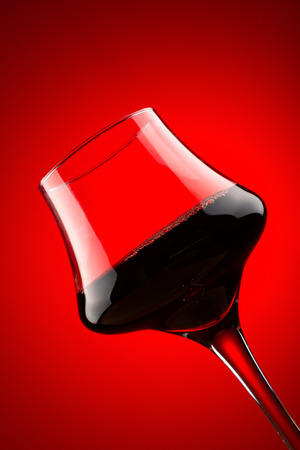 backlit cup of red wine close upの写真素材