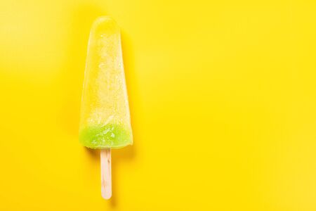 Pineapple ice pop on yellow backgroundの写真素材
