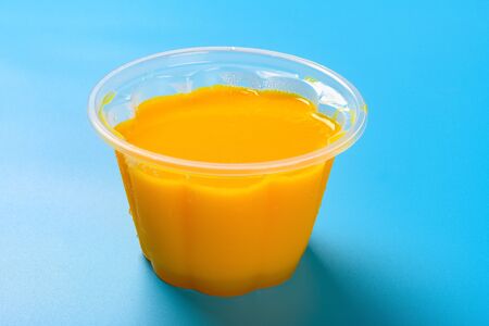 homemade mango flavor pudding on a blue backgroundの写真素材