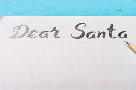 letter paper with hand written Dear Santa and a pencil on tableの写真素材