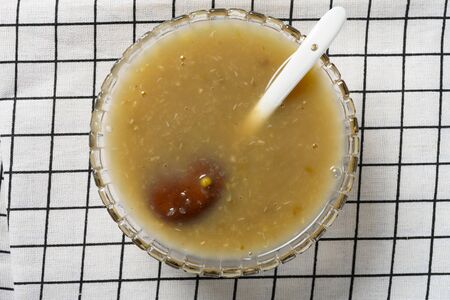 top view fresh mung bean paste syrup with orange peel on a table cloth