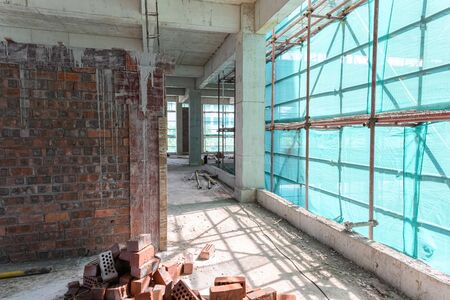 inside of an unfinshed building with protection scaffolding and netting surrounded